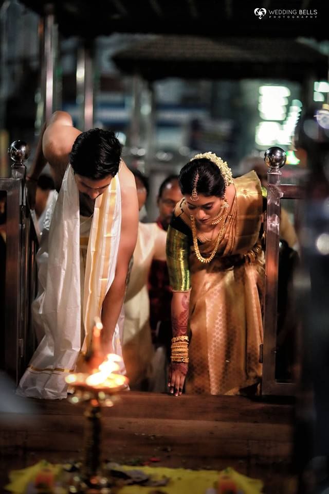 Couple at temple with oil lamp