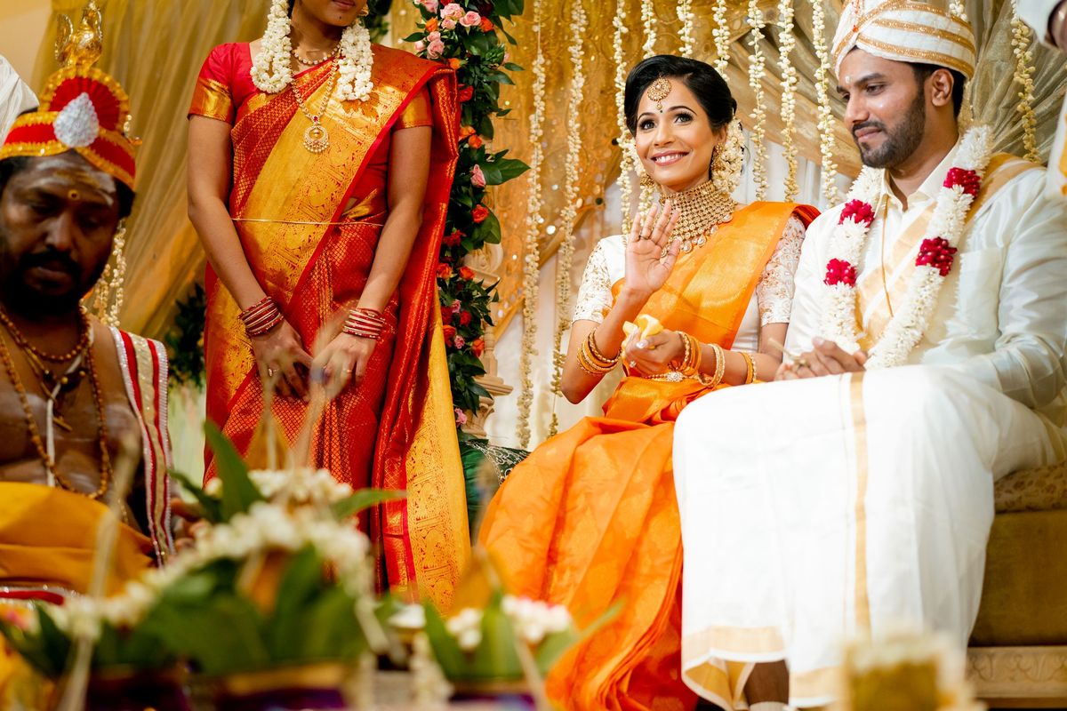 Bride in orange saree at mandap